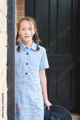 tween girl in blue primary school uniform dress photo