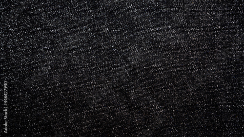 Abstract blinking background black fabric. Fabric texture with spangles
