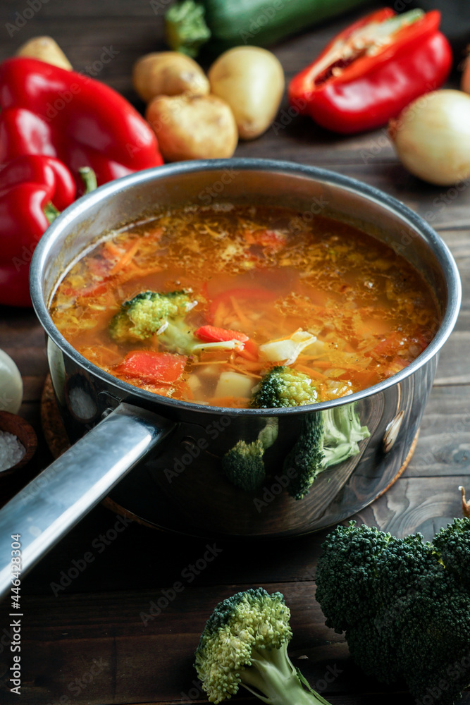 hot soup in a saucepan is steaming. with beef and vegetables. hearty, nutritious dish. dinner hot soup in a saucepan is steaming. with beef and vegetables. hearty, nutritious dish. dinner