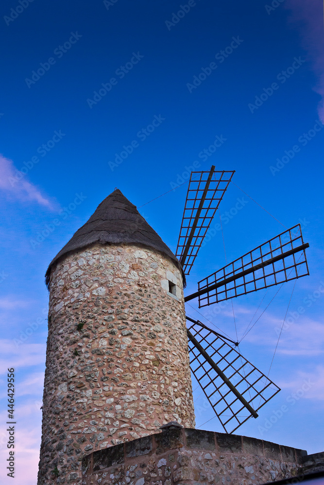 Traditional stone windmill in Sineu, central Majorca or Mallorca, after sunset against blue sky.