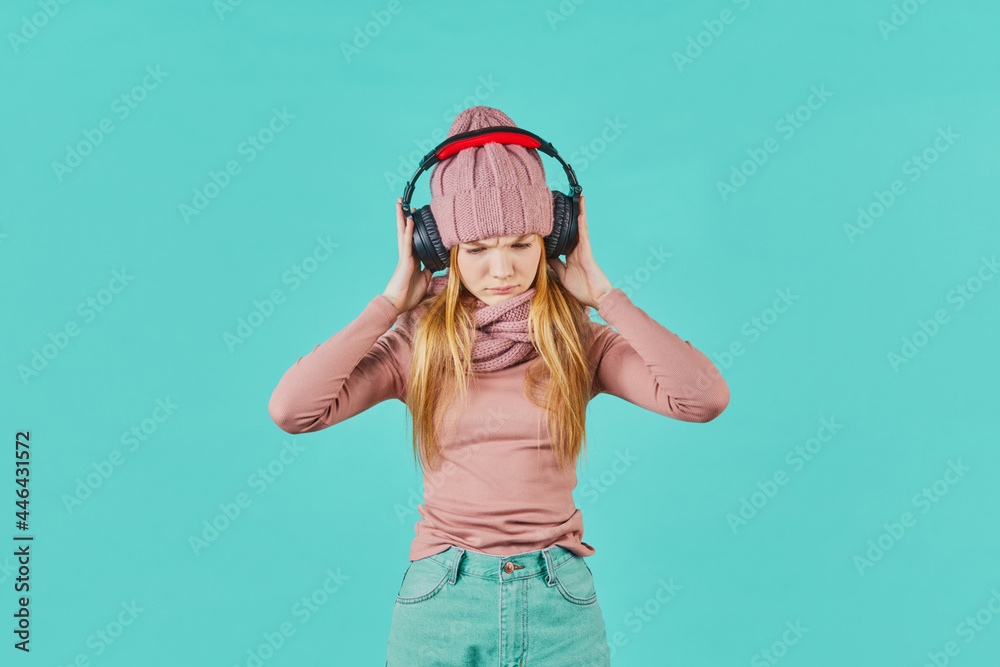 Beautiful young woman listening to music using headphones, worry for ...