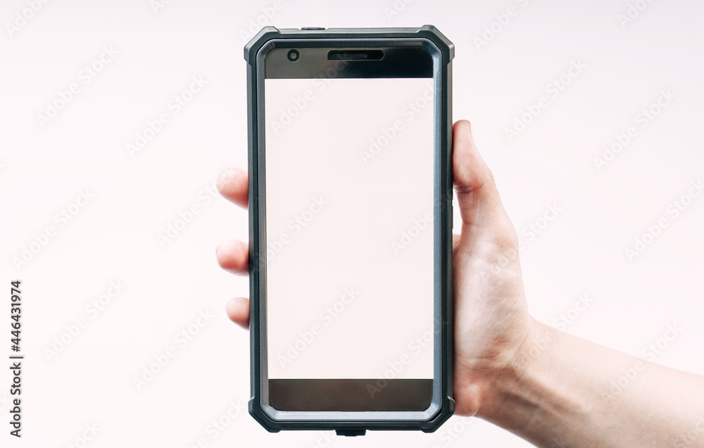 The Hand is holding a smartphone device with a white display The Hand is holding a smartphone device with a white display