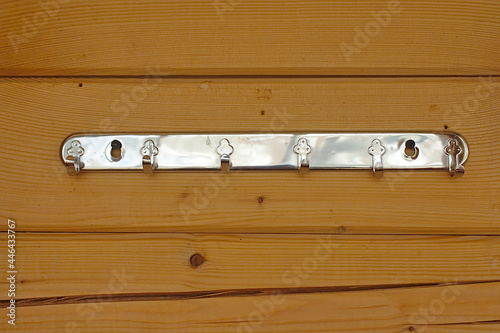 Metal hanger with hooks on a wooden wall