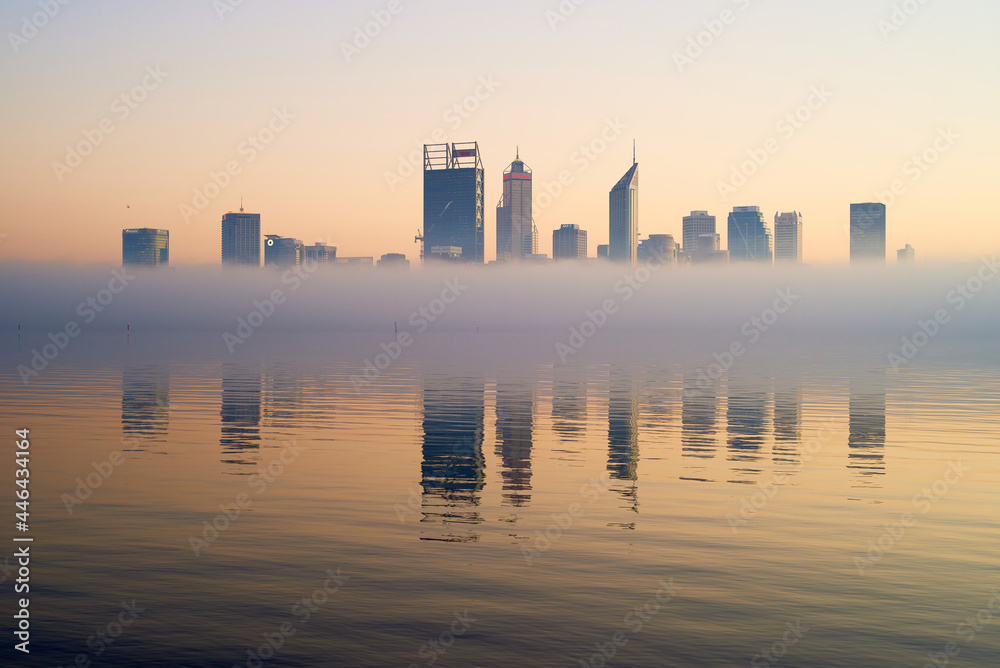 horizontal shot of Perth skyline at dawn with buildings reflected on misty water horizontal shot of Perth skyline at dawn with buildings reflected on misty water