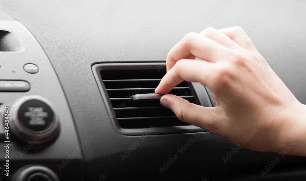 The hand adjusts the air conditioner in the car. Close up The hand adjusts the air conditioner in the car. Close up
