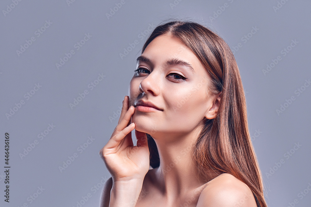 Beautiful young woman with clean perfect skin. Portrait of beauty model with natural nude makeup. Spa, skin care and wellness. Close up, gray background, copyspace. Beautiful young woman with clean perfect skin. Portrait of beauty model with natural nude makeup. Spa, skin care and wellness. Close up, gray background, copyspace.