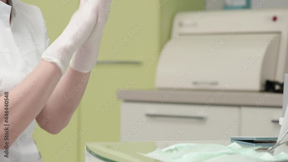 Dentist doctor putting on medical gloves in the dental office. High quality FullHD footage Dentist doctor putting on medical gloves in the dental office. High quality FullHD footage