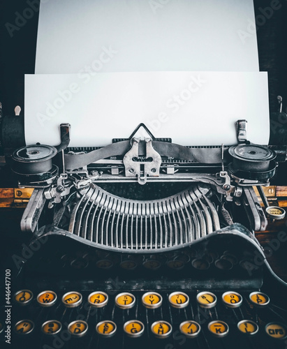 old mechanical typewriter on wooden background and blank space