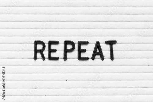 Black color letter in word repeat on white felt board background