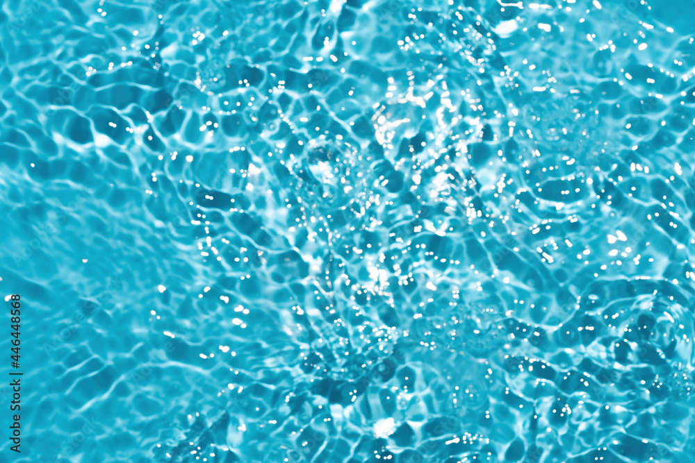 Naklejka premium Blur Reflections of blue water or cosmetic moisturiser toner or lotion light with scattered sun texture