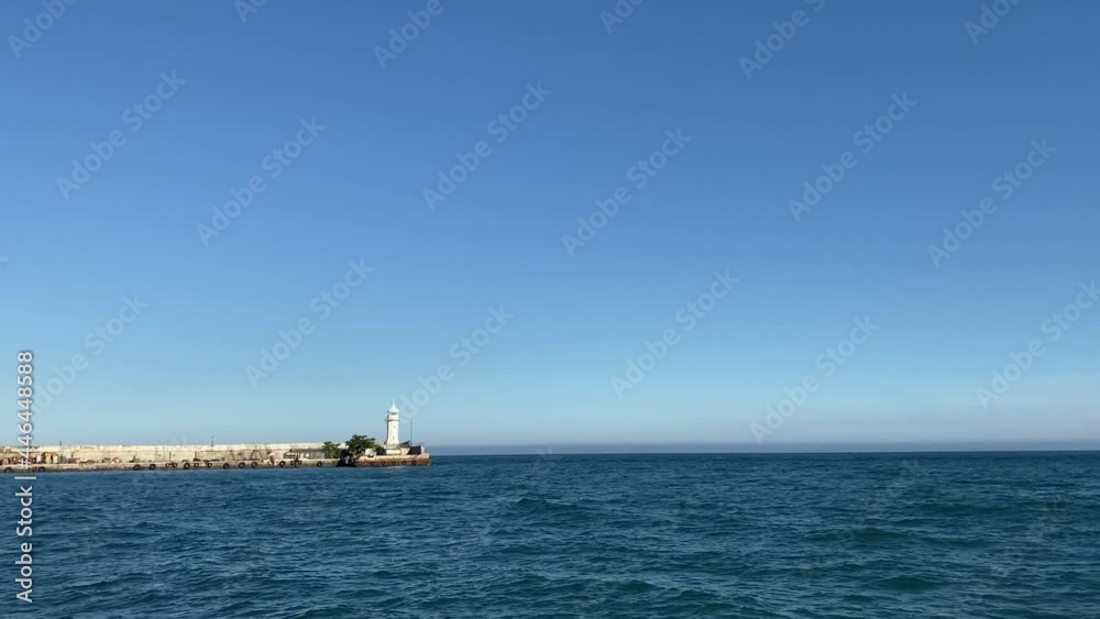 Seascape with a view of the white lighthouse. Yalta, Crimea Seascape with a view of the white lighthouse. Yalta, Crimea