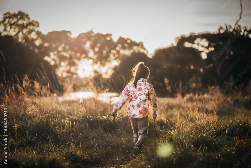 Little girl walking near a lake Little girl walking near a lake