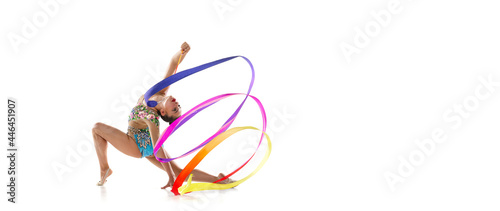 Flyer. One female rhythmic gymnast in motion and action with colorful ribbon isolated over white studio background.
