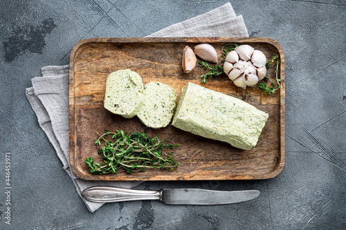 Homemade Butter with thyme and rosemary and lemon zest, on gray stone background, with copy space for text photo