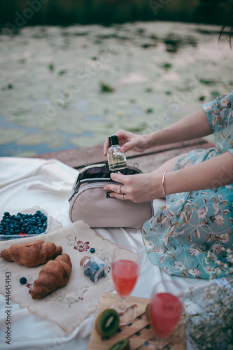 the girl takes out her perfume from her purse