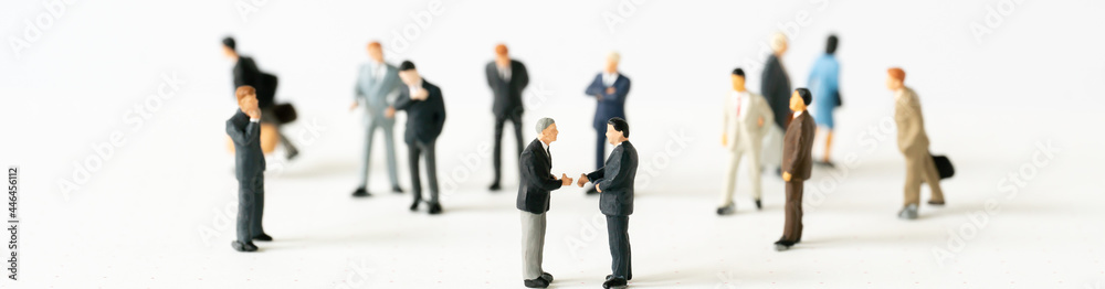 Miniature businessman shake hand partner client customers on stage with success dealing business using as contract commitment agreement investment and partnership business development cover page ads Miniature businessman shake hand partner client customers on stage with success dealing business using as contract commitment agreement investment and partnership business development cover page ads