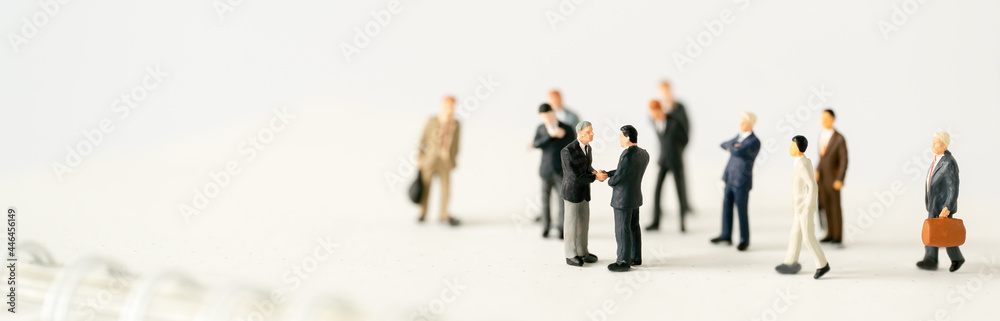 Miniature businessman shake hand partner client customers on stage with success dealing business using as contract commitment agreement investment and partnership business development cover page ads Miniature businessman shake hand partner client customers on stage with success dealing business using as contract commitment agreement investment and partnership business development cover page ads