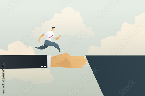 Businessman hand is a bridge that helps the businessman run cross the cliff