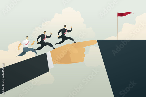 Businessman hand points to a flag placed on the top of a cliff