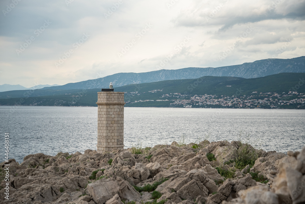 Silo lighthouse in Punta Silo (šilo), Kvarner bay on Krk island, Croatia and the view of Crikvenica 