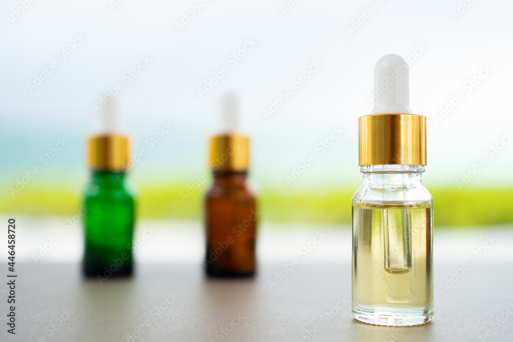 Set of multi color glass bottles with dropper on the table. Concept of aroma oil, cosmetic and beauty skin. Set of multi color glass bottles with dropper on the table. Concept of aroma oil, cosmetic and beauty skin.