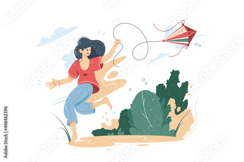 Happy smiling woman flying a kite