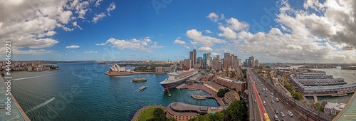 Aerial panoramic view of Sydney harbor from Harbor Bridge with skyline, opera house and cruise terminal