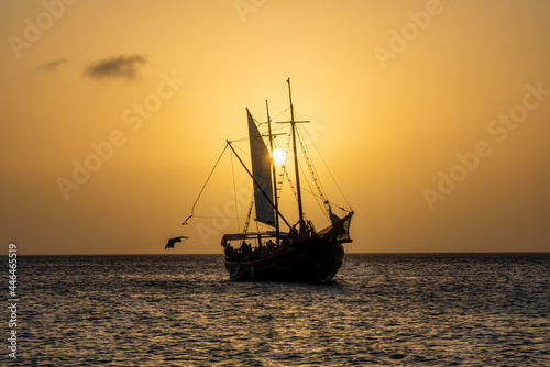 A sail boat silhouette against the sunset