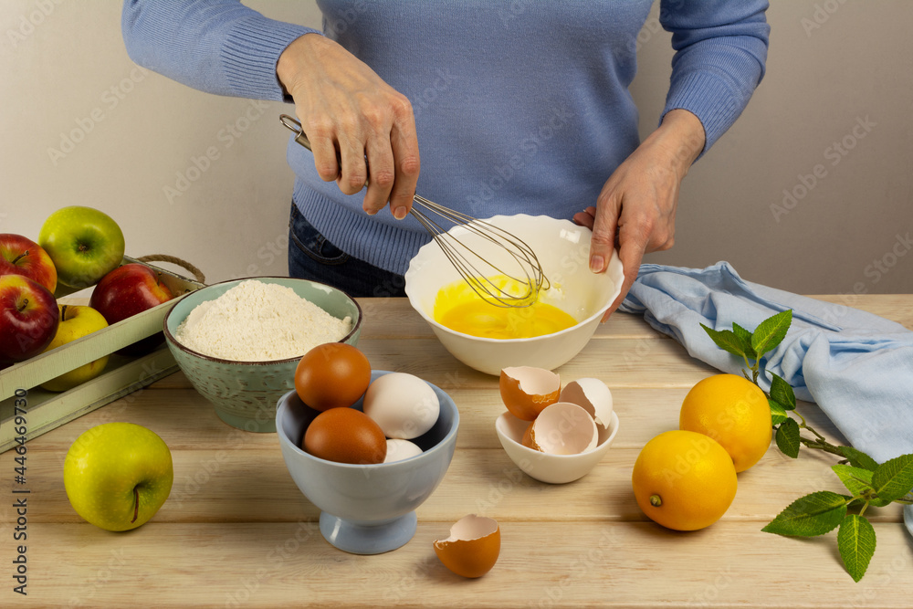 Woman cooking pie dough in the bowl and fruits Woman cooking pie dough in the bowl and fruits
