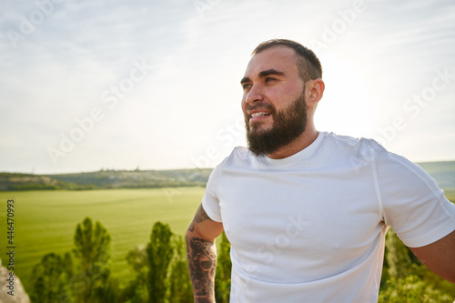 Young bearded man portrait outdoors in the mountains