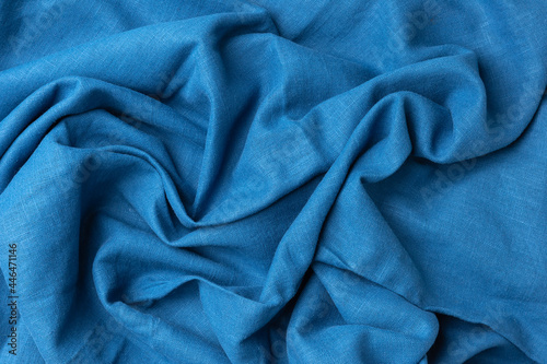 Textured, abstract, background. Cotton textile blue fabric luxurious softness smooth for design backdrop.