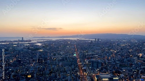 UMEDA, OSAKA, JAPAN : Aerial high angle sunset view of CITYSCAPE of OSAKA. View of buildings and street around Osaka and Umeda station. Wide view time lapse shot, dusk to night.