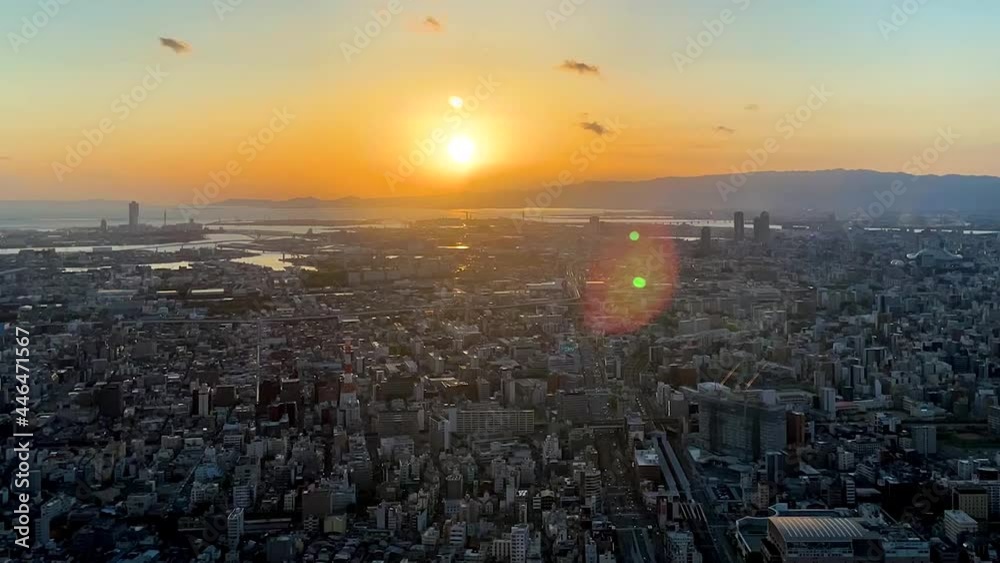 UMEDA, OSAKA, JAPAN : Aerial high angle sunset view of CITYSCAPE of OSAKA. View of buildings and street around Osaka and Umeda station. Wide view time lapse tracking shot, dusk to night.