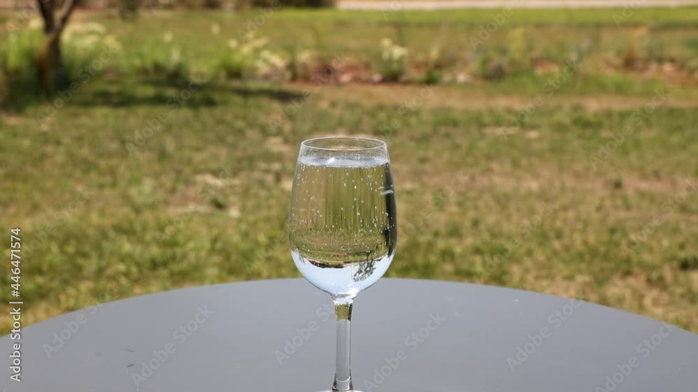 Beautiful view of glass of cold sparkled mineral water on table outdoor on warm summer day. Greece. Beautiful view of glass of cold sparkled mineral water on table outdoor on warm summer day. Greece.
