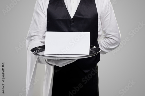 Obraz na płótnie Elegant waiter with blank menu on tray