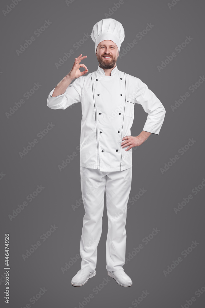 Confident chef in uniform showing okay gesture
