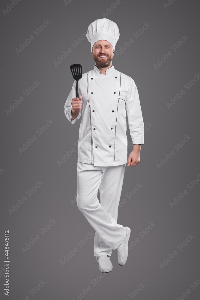 Happy chef with spatula looking at camera Happy chef with spatula looking at camera