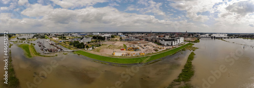 Wide panoramic view on PUUR21 new housing construction project part of urban development plan Noorderhaven neighbourhood during high water level of river IJssel