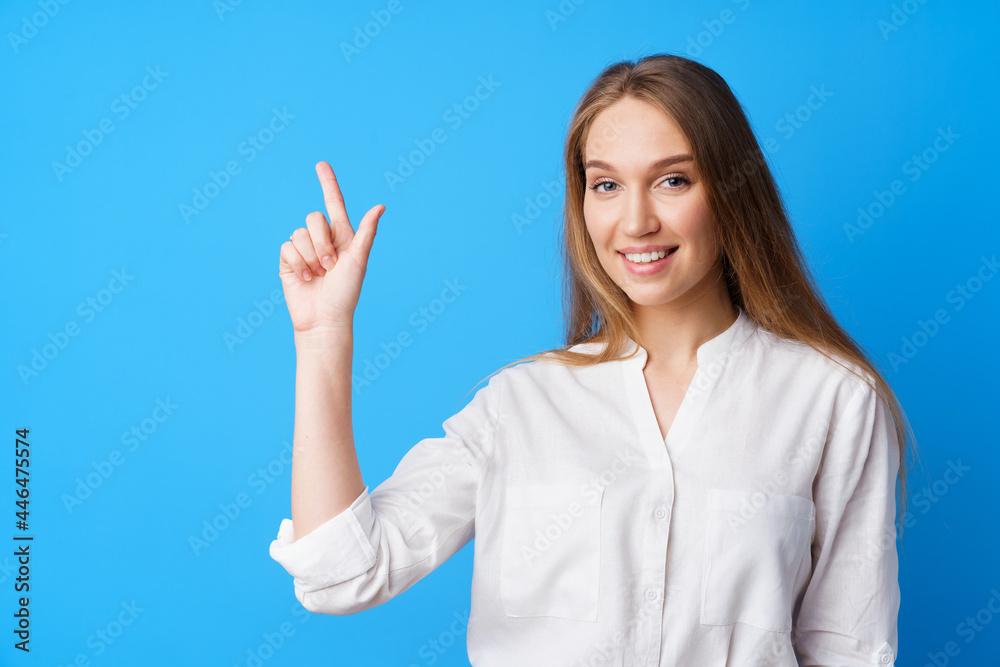Pretty nice young woman pointing to copy space for advertising Pretty nice young woman pointing to copy space for advertising