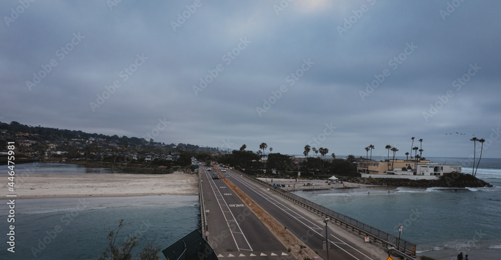 Cars on small bridge over San Diego beach