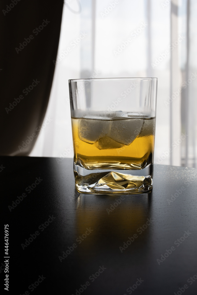 Whisky with ice on the table 