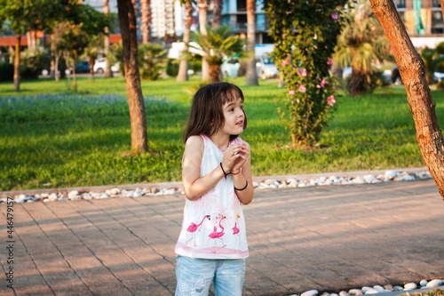 Little girl having fun outdoors in sunset