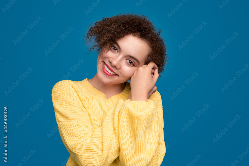 Smiling curly haired woman in knitted sweater Smiling curly haired woman in knitted sweater