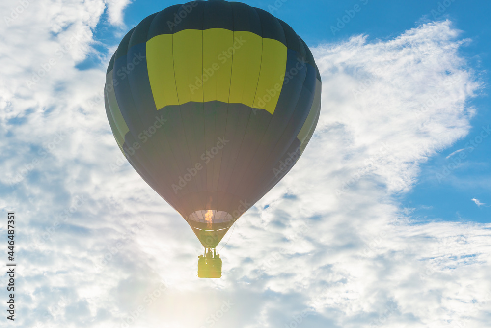 Fototapeta premium Hot Air Balloon and blue sky white cloud.Blue yellow hot air balloon in the air at summer evening.