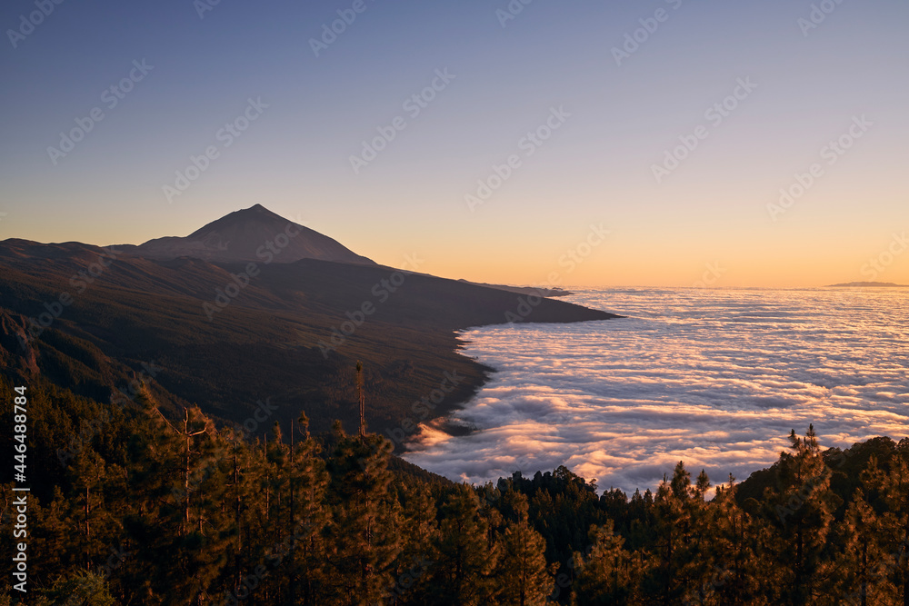 Landscape with volcano Pico de Teide above clouds at beautiful dusk. Tenerife, Canary Islands, Spain.