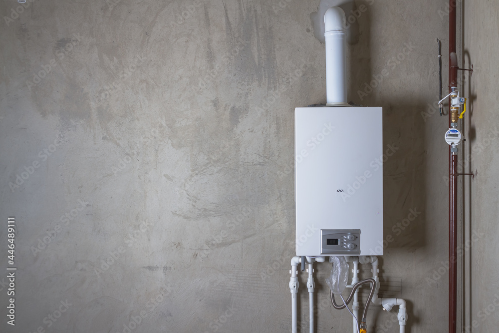 White tankless water heater on concrete wall