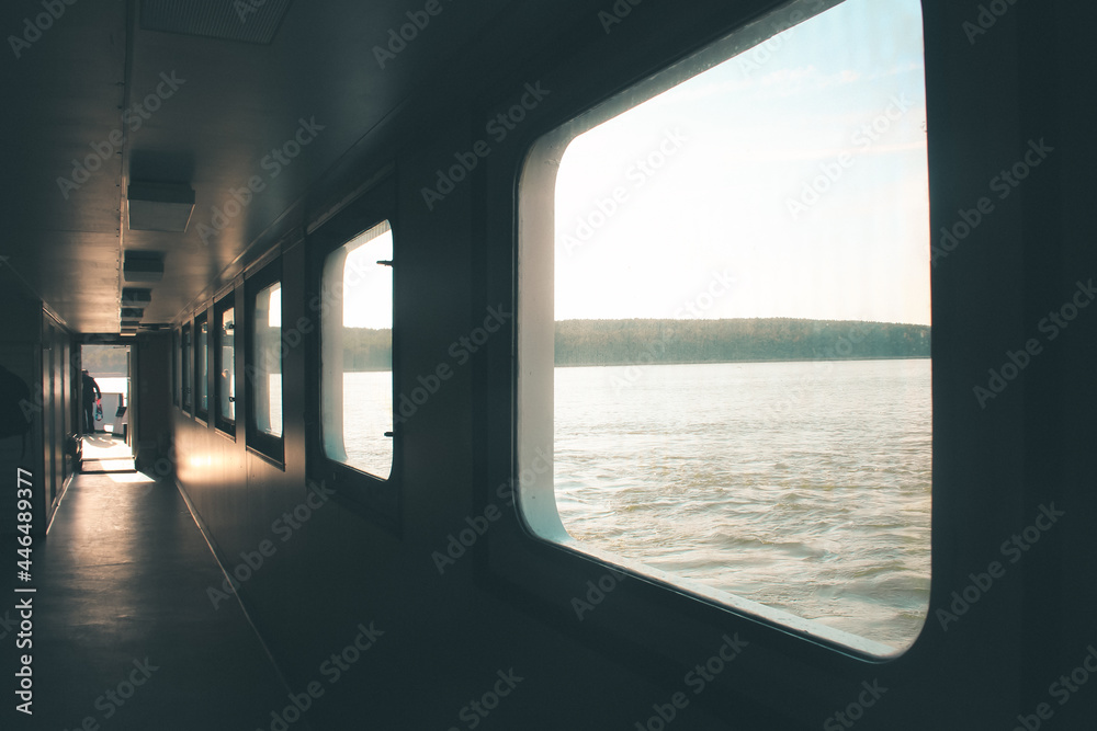 Ferry corridor, square windows, light falls on the floor. Transit from Klaipeda to the Curonian Spit