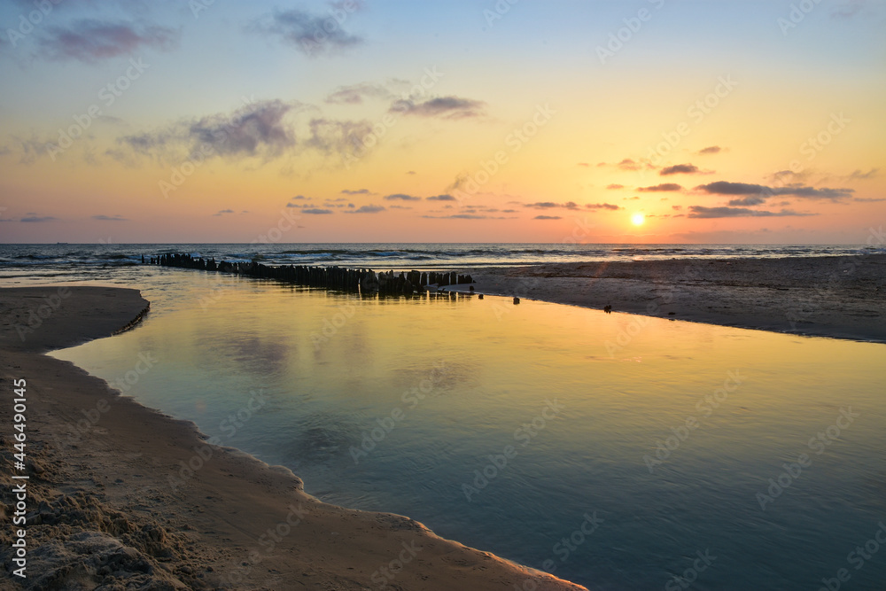the Piasnica River flows into the Baltic Sea in Poland, a beautiful sunrise 