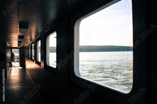 Ferry corridor, square windows, light falls on the floor. Transit from Klaipeda to the Curonian Spit