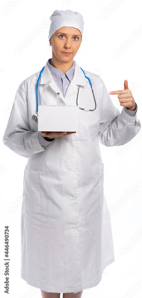 female doctor in a white coat and hat. a medic holds a white box and a vial with a vaccine, medicine, points a finger at them. vaccination of the population. white background, isolated female doctor in a white coat and hat. a medic holds a white box and a vial with a vaccine, medicine, points a finger at them. vaccination of the population. white background, isolated